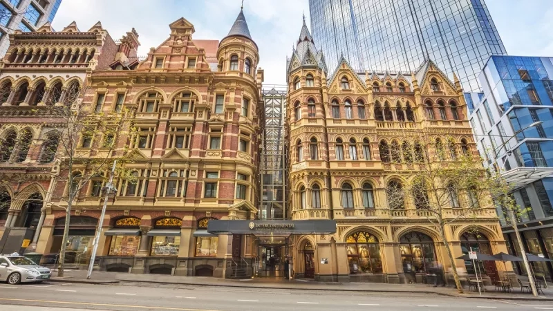 Exterior of Intercontinental Melbourne the Rialto Hotel, a large building with a modern glass tower in the background.