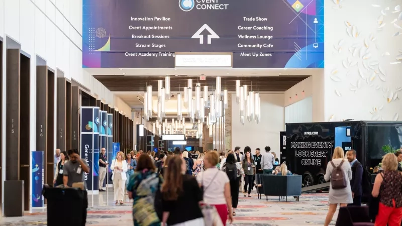 A large group of people in the Cvent Connect 2023 conference with an Innovation Pavilion sign above.