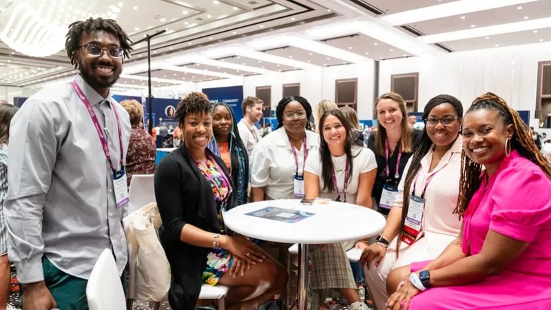 Group of young professionals smiling at the camera while attending an event at the Gaylord Opryland Resort.