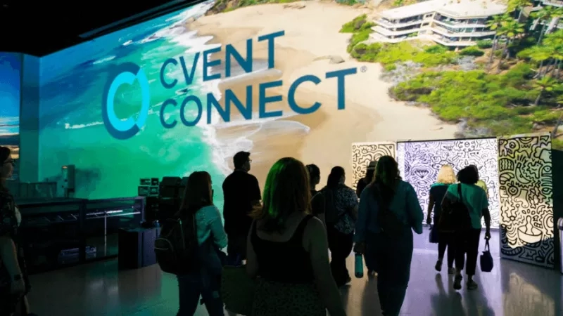A group of people walking toward the screen with the text Cvent Connect on a large screen.
