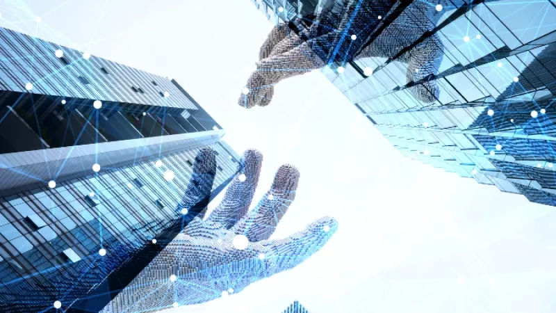 Hands reaching out to each other in front of an architectural background of a building with blue accents.