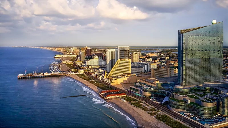 A cityscape of Atlantic City, New Jersey, with the ocean, boardwalk, and skyscrapers like Borgata Hotel Casino & Spa.