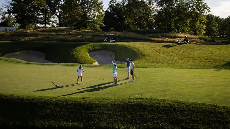 Group of golfers on the green at Cog Hill Golf & Country Club.