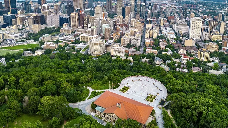 Montreal, Canada, top-down view of a cityscape with trees, gardens, and buildings, showcasing urban architecture and landscaping.