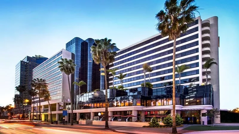 The London West Hollywood at Beverly Hills exterior with palm trees and architecture at dusk.