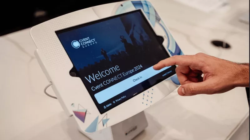 A person is pointing to the touchscreen device with the text "Welcome Event Connect Europe 2024".