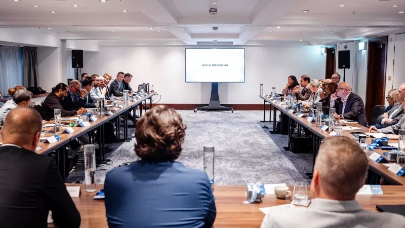 Cvent CONNECT Europe 2024 group discussion in meeting room with large screen and speakers.