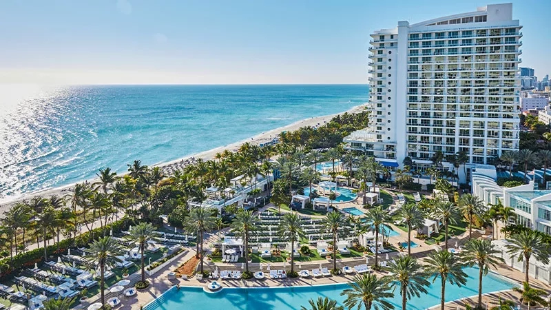 Fontainebleau Hotel with ocean views and pools, showcasing architecture, landscaping, and ambiance in a coastal setting.