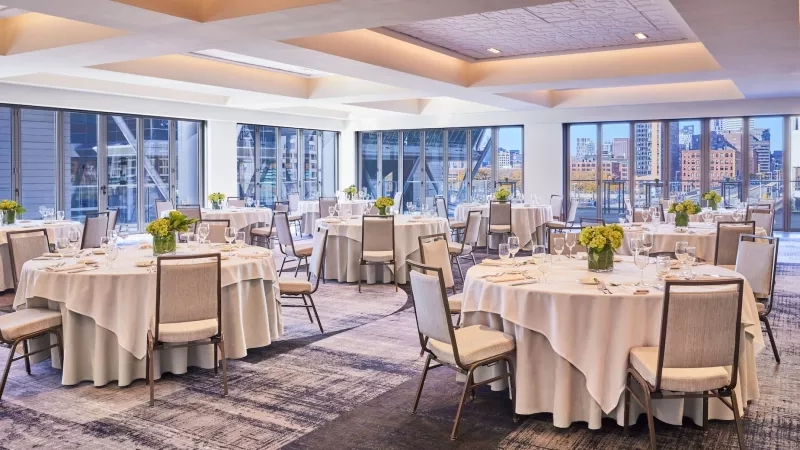 BOSSEA Contemporary Meeting Room Social Set with round tables and cityscape view from the floor-to-ceiling windows.