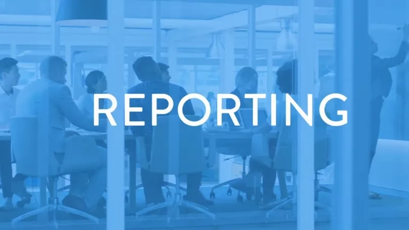 Office workers sit at a table with the word "Reporting" in front of them, while a man stands behind them.