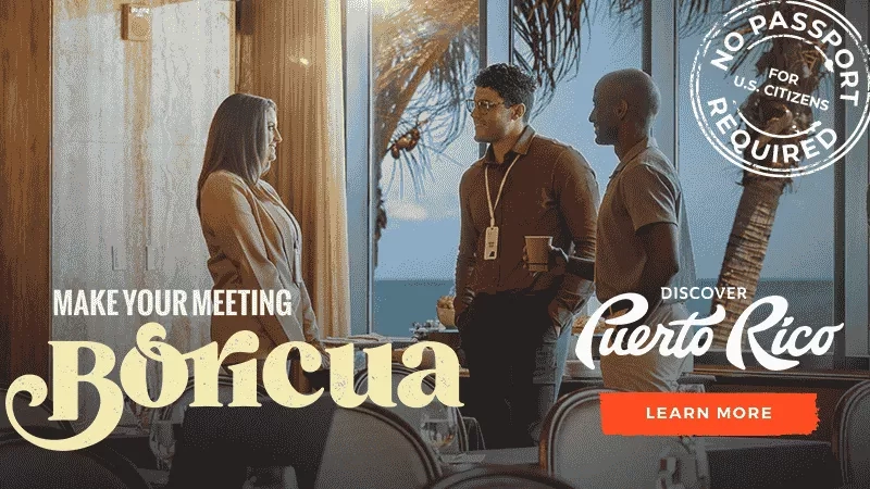 A group of people in a conference room at Boricua in Puerto Rico with a sign that says "No passport required".