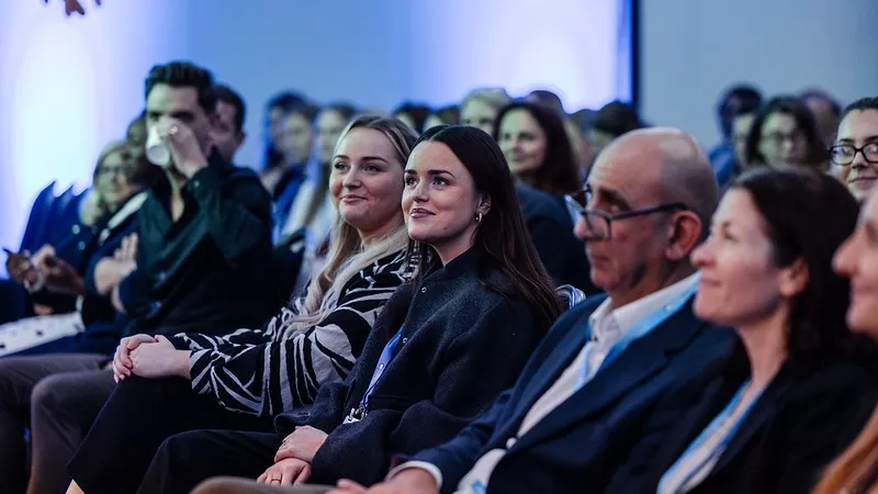 Picture of attendees at a conference in theatre style format