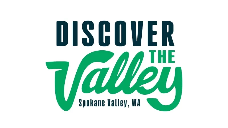 Discover the Valley logo, Spokane Valley, WA, with green and black text on a white background.