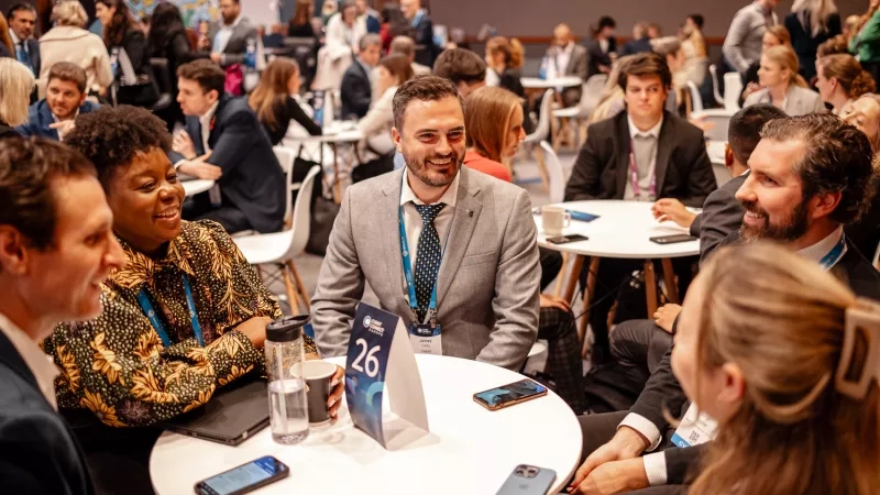Attendees network at Cvent CONNECT Europe 2024, a trade show with a vibrant atmosphere and modern architecture.