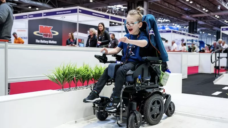 Wheelchair user using ramp at exhibition