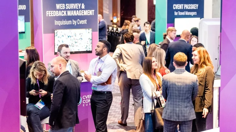 Business professionals at an event in the lobby of a hotel.
