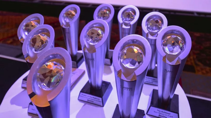 Trophies on a table with one that says "The Achiever Best Return on Event SevOne."