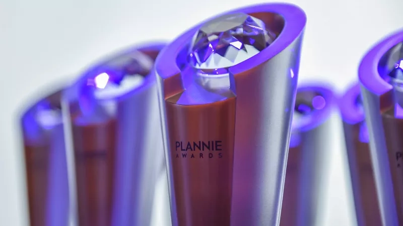 Plannie awards with purple light shining through the glass and diamond on top of the glass.