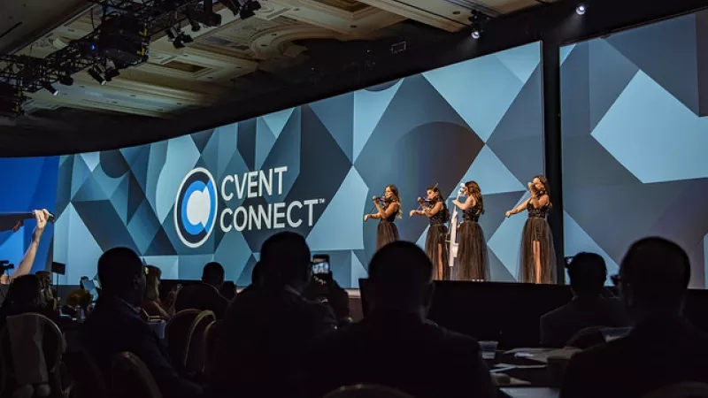 Four women performing on stage in front of a large audience at Cvent Connect in Las Vegas.