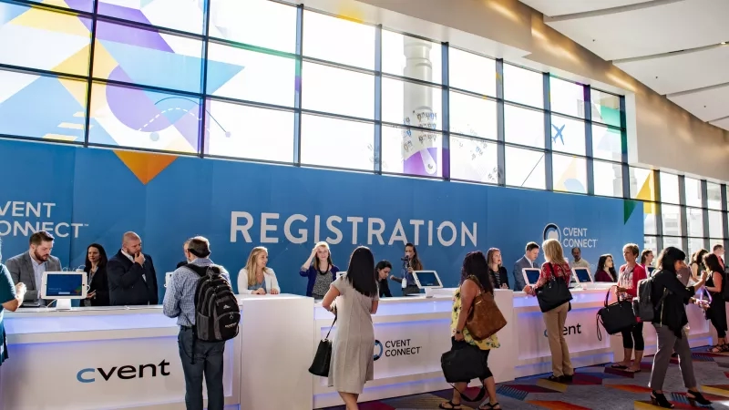 People standing in line at a registration counter at Cvent Connect in the Washington, D.C. Metro area.