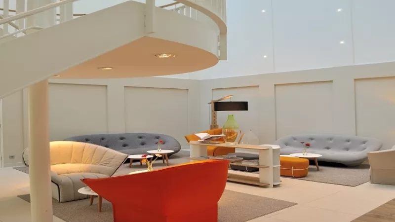 A photo of a living room at the hotel 101 Copenhagen, featuring couches and lamps.