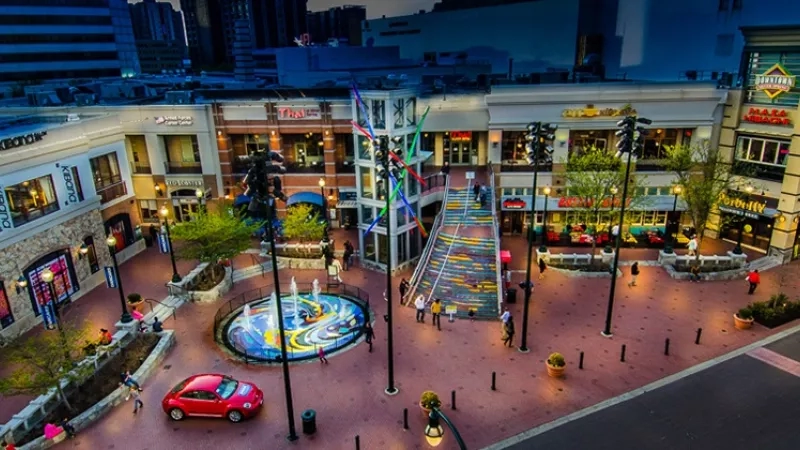 The aerial view of the CityVista's shopping center with buildings, landscaping, and a fountain.