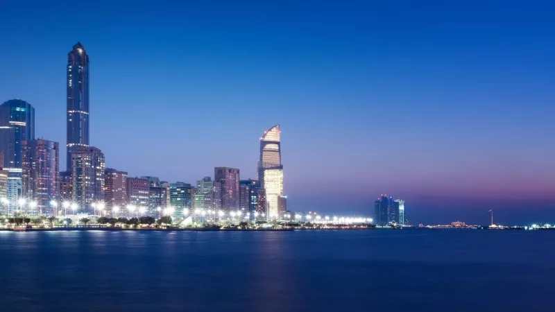 A mesmerizing view of Abu Dhabi Corniche's skyline at dusk, showcasing modern architecture and serene ambiance.