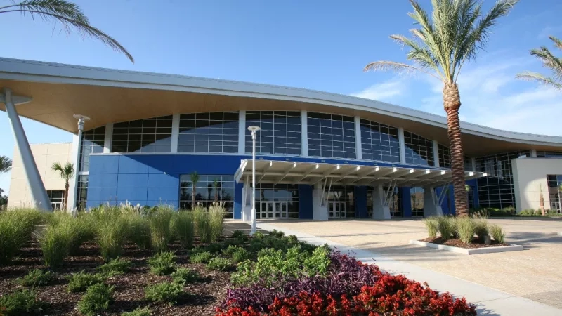 Front view of the Coliseum Convention Center with landscaping and palm trees in Biloxi, Mississippi Gulf Coast.