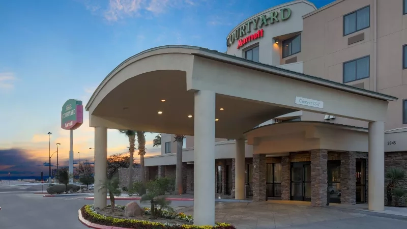 Exterior view of the entrance to the Courtyard Las Vegas South with landscaping and a sign.