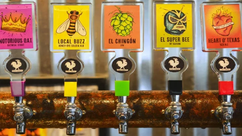 Five beer taps with colorful labels and artwork on them at Torchy's Tacos in Austin, Texas.