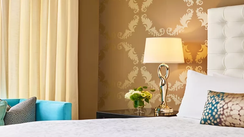 A luxurious guest room at The Ritz-Carlton, New York, NoMad with a bed and a sofa.