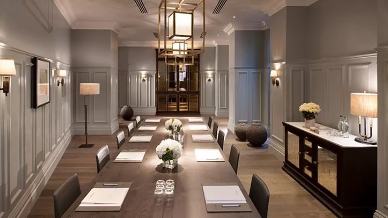 The Boardroom at the Ritz Carlton, a large meeting room with long tables and chairs.
