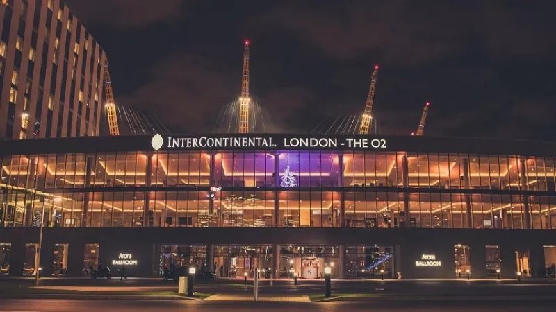 The Intercontinental London - O2 hotel with lit windows and a Christmas tree at night.