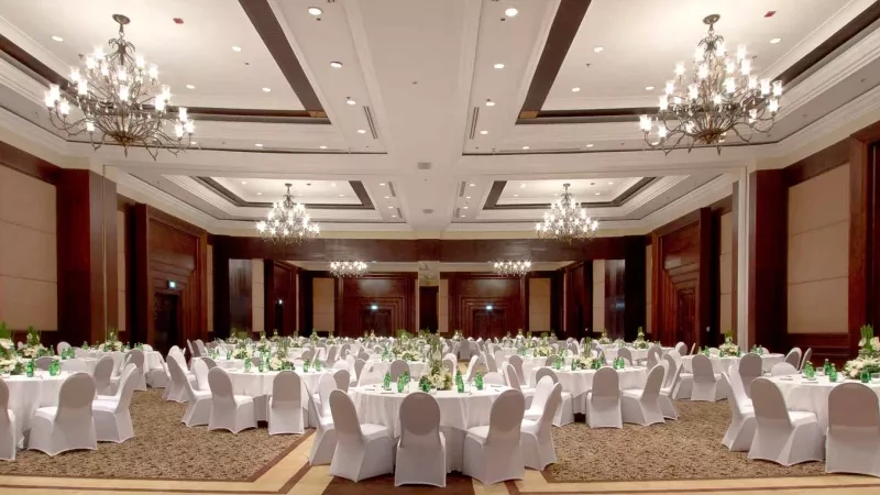 RIMBA Ballroom with white chairs and tables covered with white cloths in Shangri-La Hotel, Kuala Lumpur.