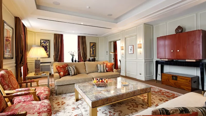 The Presidential Suite at the Four Seasons Hotel George V Paris has a living room with a sofa and table.