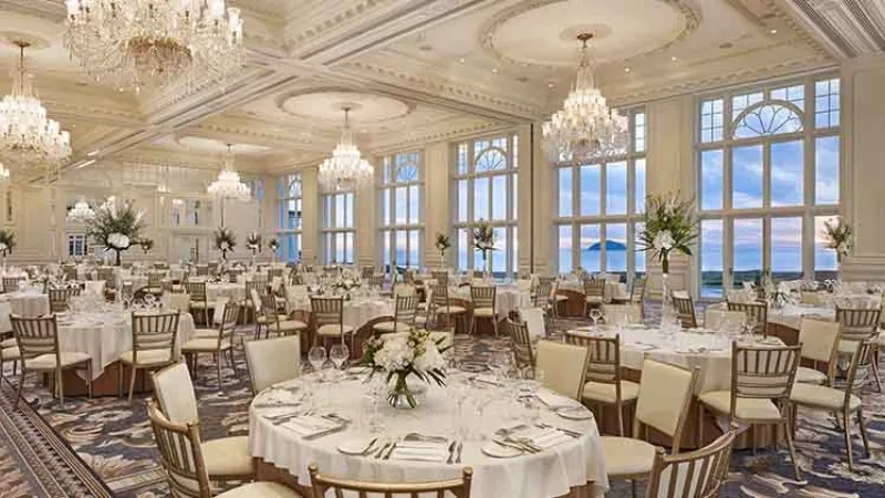 A grand banquet hall with elegant decor and panoramic views, showcasing luxury at Trump International Hotel.