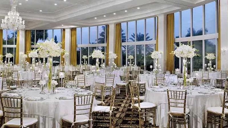 Large, elegant banquet hall with tables set for a formal event at Trump Hotels.