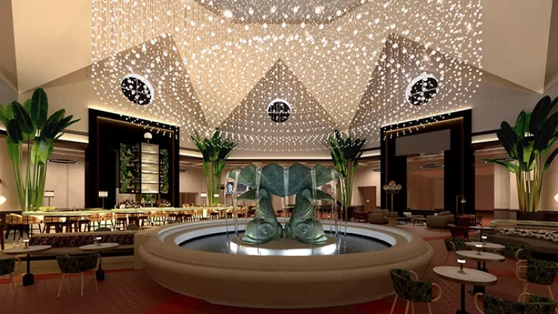 An interior view of the lobby of the Ritz-Carlton Residences with a water fountain in the middle.