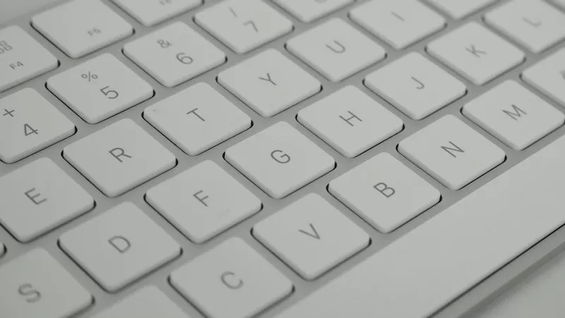 Close-up of a white keyboard with letters and numbers, highlighting technology and design.
