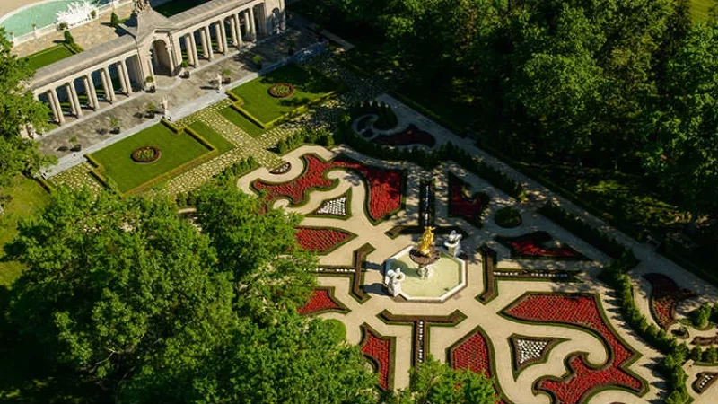 Aerial view of the Château de la Motte Fénelon gardens, showcasing intricate landscaping and architectural beauty.