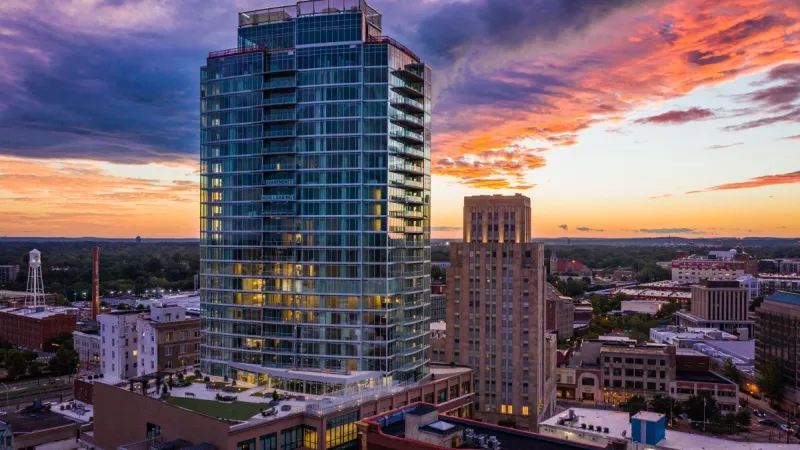 Cityscape with Headliner at sunset, showcasing architecture, landscaping, and vibrant ambiance in Durham, North Carolina.