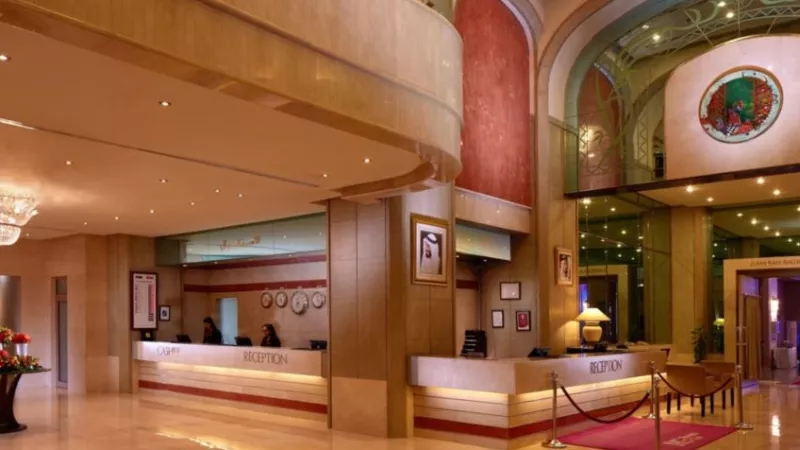 Hotel lobby with reception desk, red carpet, and elegant interior design at the Grand Plaza Mövenpick.