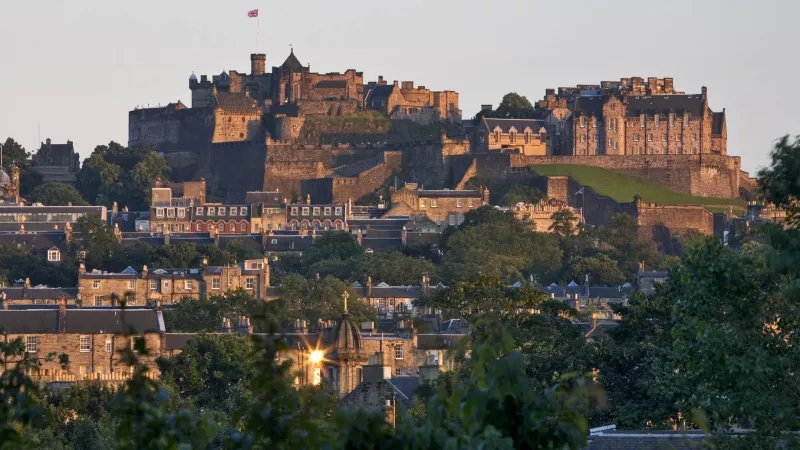 Edinburgh Castle, the castle on the hill in Edinburgh, and the buildings in the city below.