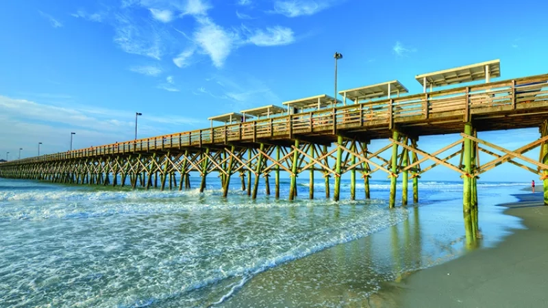 Photo of the Folly Beach Pier with solar panels installed on top of the pier.