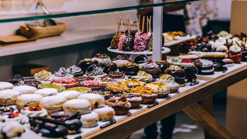 A glass display case showcasing an array of delectable desserts and pastries for the eyes to feast on.