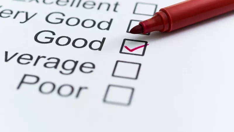 A red marker is placed on top of a paper that has the text "Good" checked.
