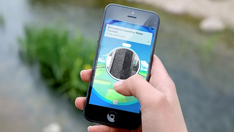 An iPhone shows the location of a Pokemon on the screen.