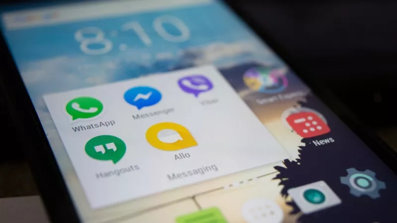 An Android phone with WhatsApp, Messenger, Viber, and Allo messaging apps on the screen.