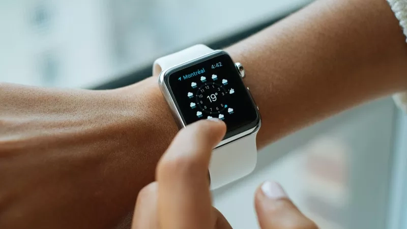 Close up of an Apple watch showing the weather forecast for Montreal on the screen.