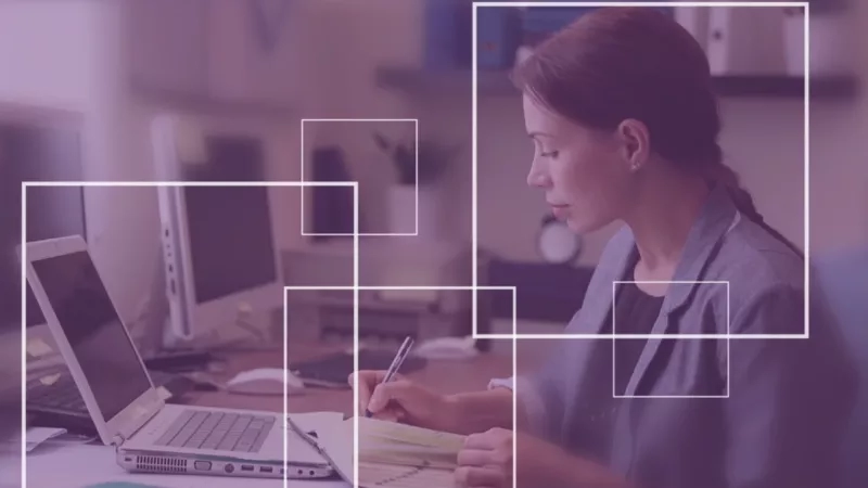 Woman working on laptop in office, illustrating the power of insights.